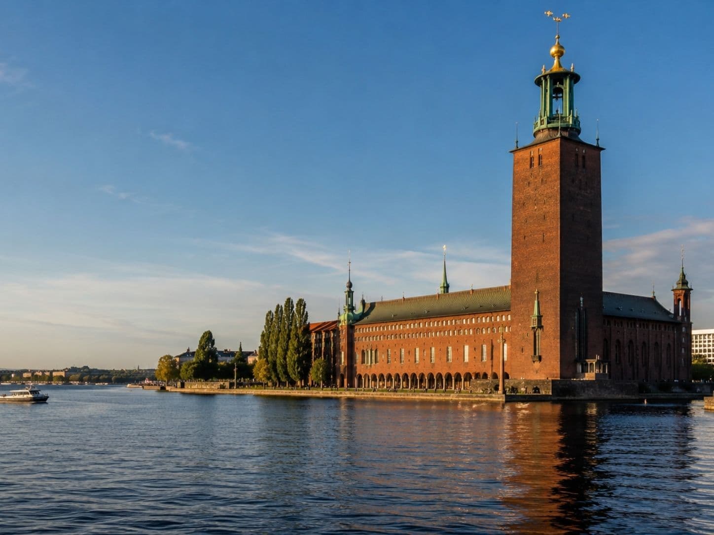 Stockholm City Hall beside Lake Mälaren in warm evening light